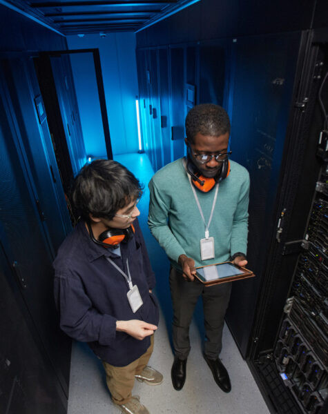 Two Network Engineers in Data Center Server room of data center